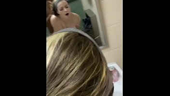 A pretty girl experiences pleasure in a public restroom